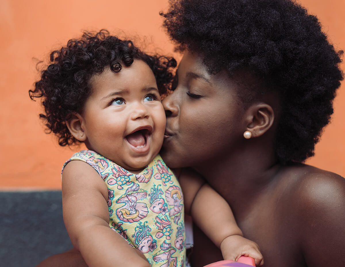 Mom Kissing Daughter